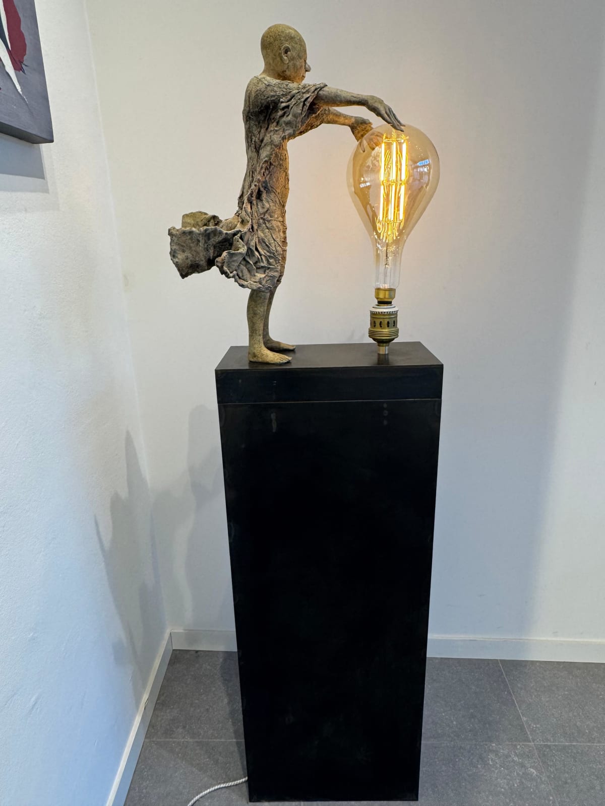 IIXV Visionary XL with light boy sculpture bronze sculpture of Lieven d'Haese garden sculpture boy opening arms to light up a light bulb in his hands with imagination magic dream contemporary art sculpture light interior design at Art Yi gallery in Brussels