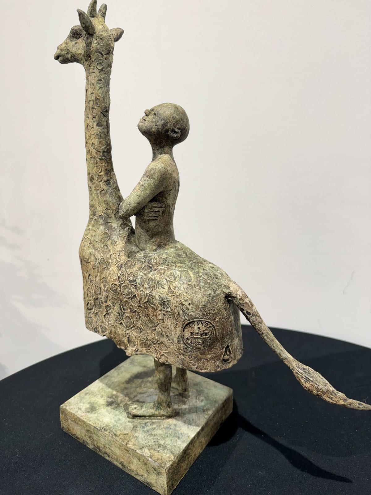 Two legs giraffe sculpture lieven D'haese contemporary sculpture bronze sculpture of a little boy who is riding on a giraffe animal sculpture child sculpture dream childhood Art Yi gallery Brussels art gallery