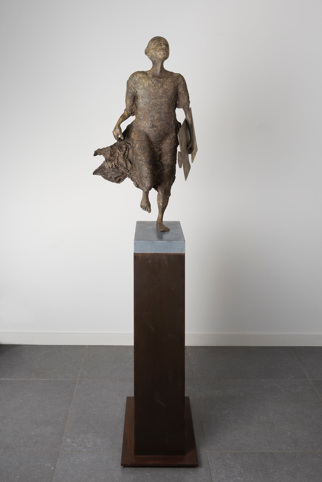 Ontbrekende schakel lieven d'haese hedendaagse bronzen sculptuur een jongen die rent met een puzzel sculptuur kindersculptuur kindertijd Art Yi tuin beeldentuin art design kunstgalerie in brussel