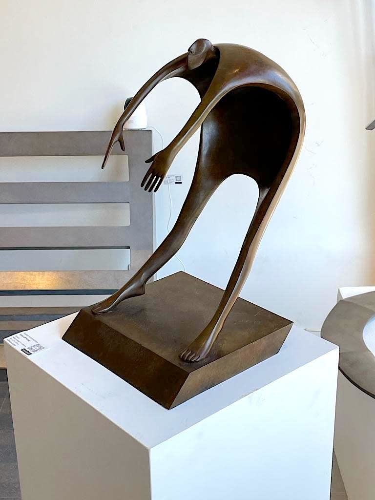 Isabel miramontes contemporary bronze sculpture abstract art sculpture decoration design minimalism a man flying or heading towards the sky in a gust of wind