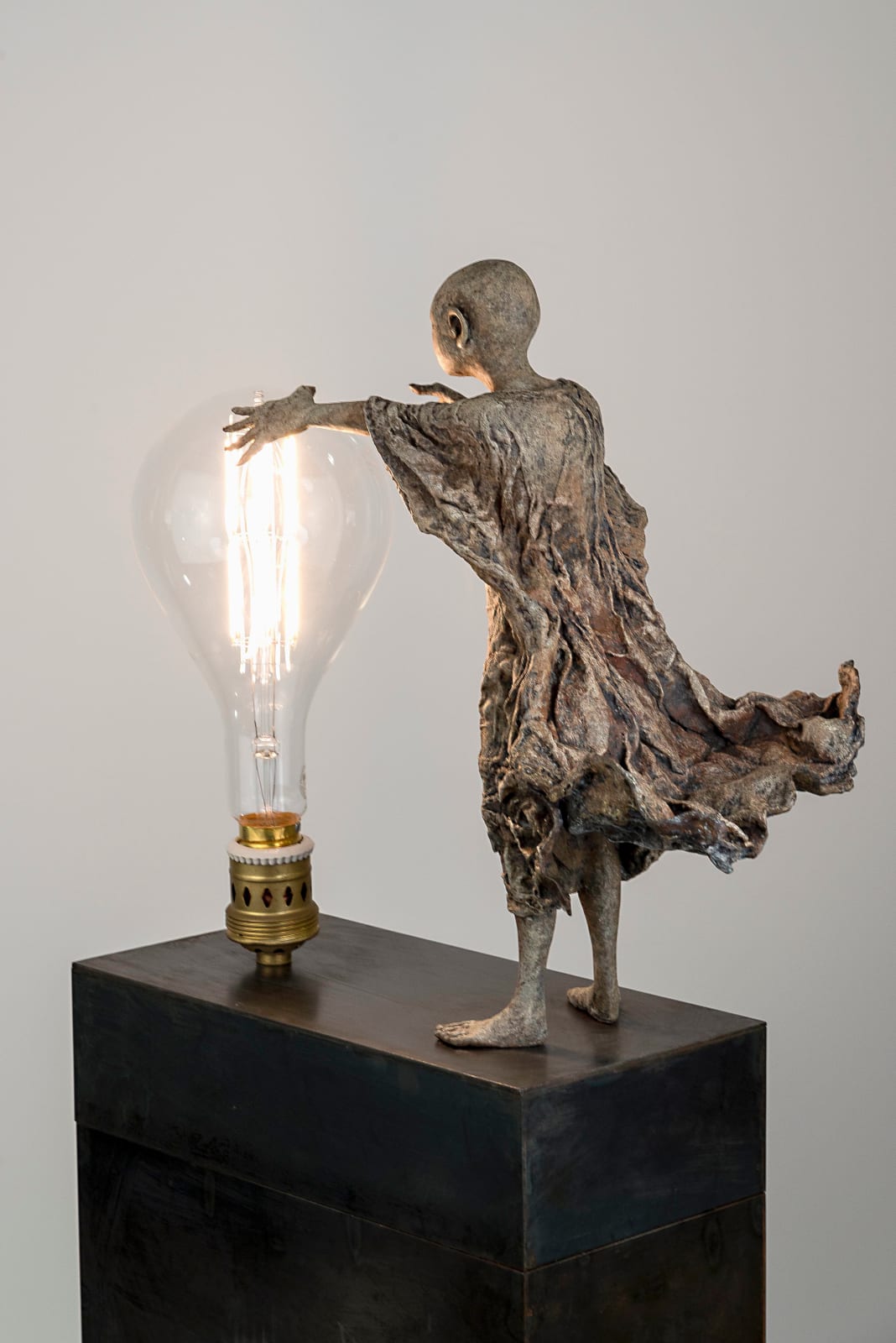 Visionnaire lieven d'haese sculpture contemporaine en bronze d'un garçon allume une ampoule avec son imagination et son inspiration une sculpture art du rêve Art Yi galerie d'art à bruxelles