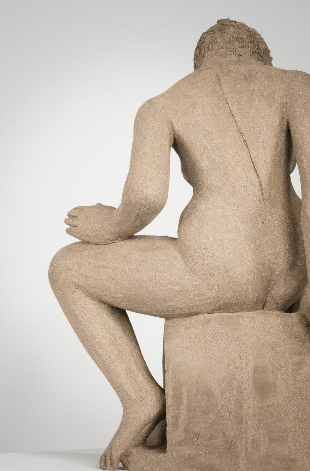 Figurative ceramics sculpture by artist Emilio DiIorio. Female figure is No. 4 in artist's Seated Bathers series in gray clay.
