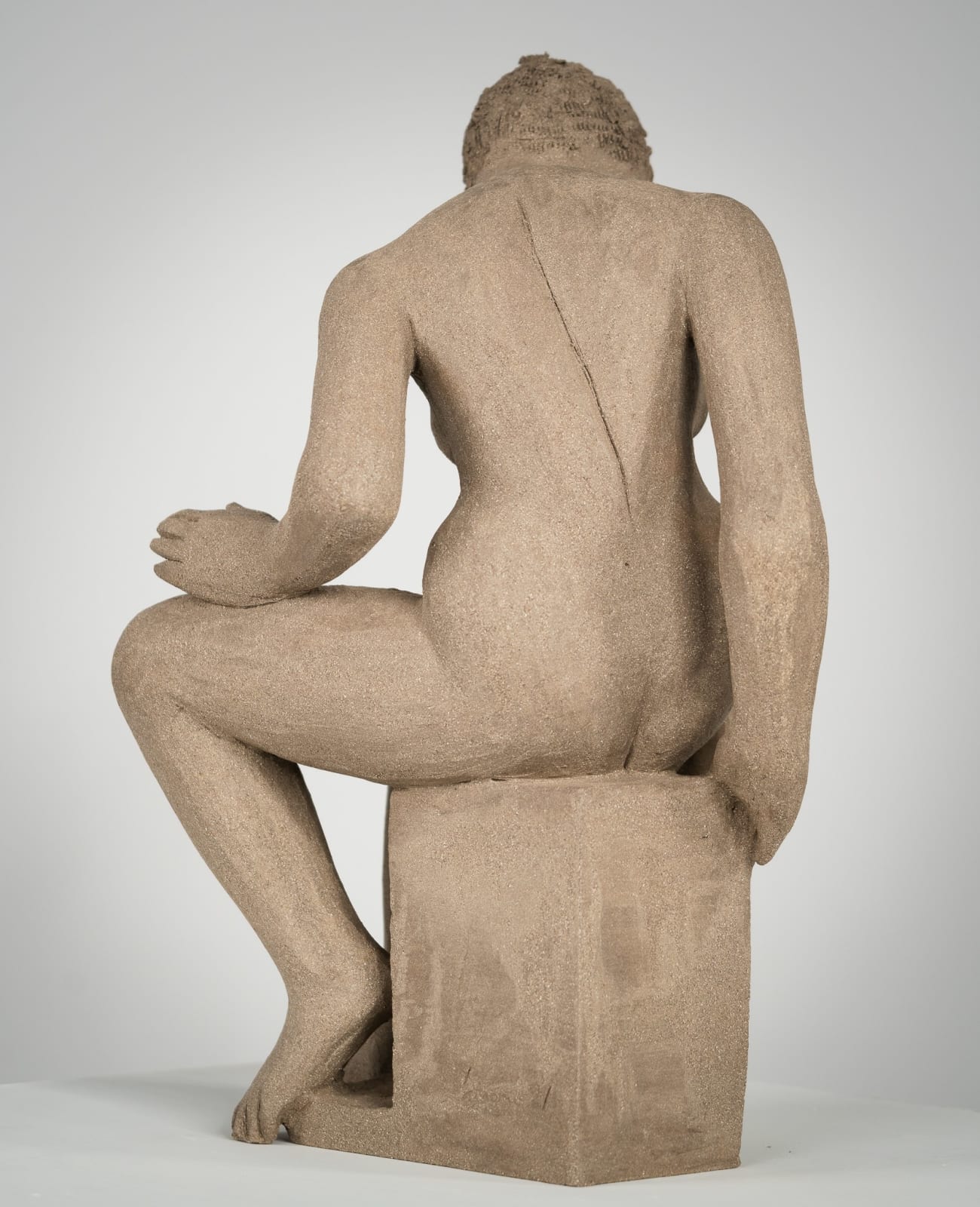 Figurative ceramics sculpture by artist Emilio DiIorio. Female figure is No. 4 in artist's Seated Bathers series in gray clay.