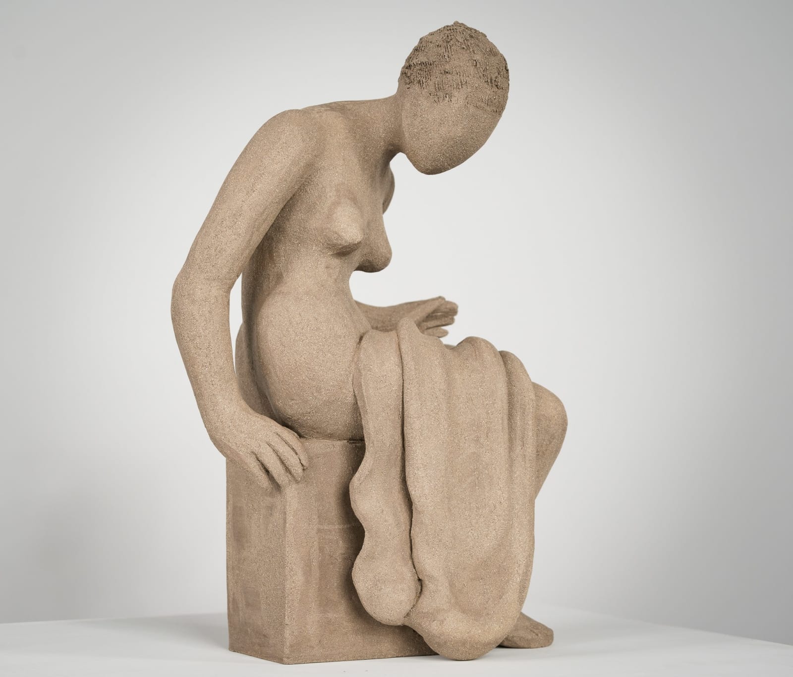 Figurative ceramics sculpture by artist Emilio DiIorio. Female figure is No. 4 in artist's Seated Bathers series in gray clay.