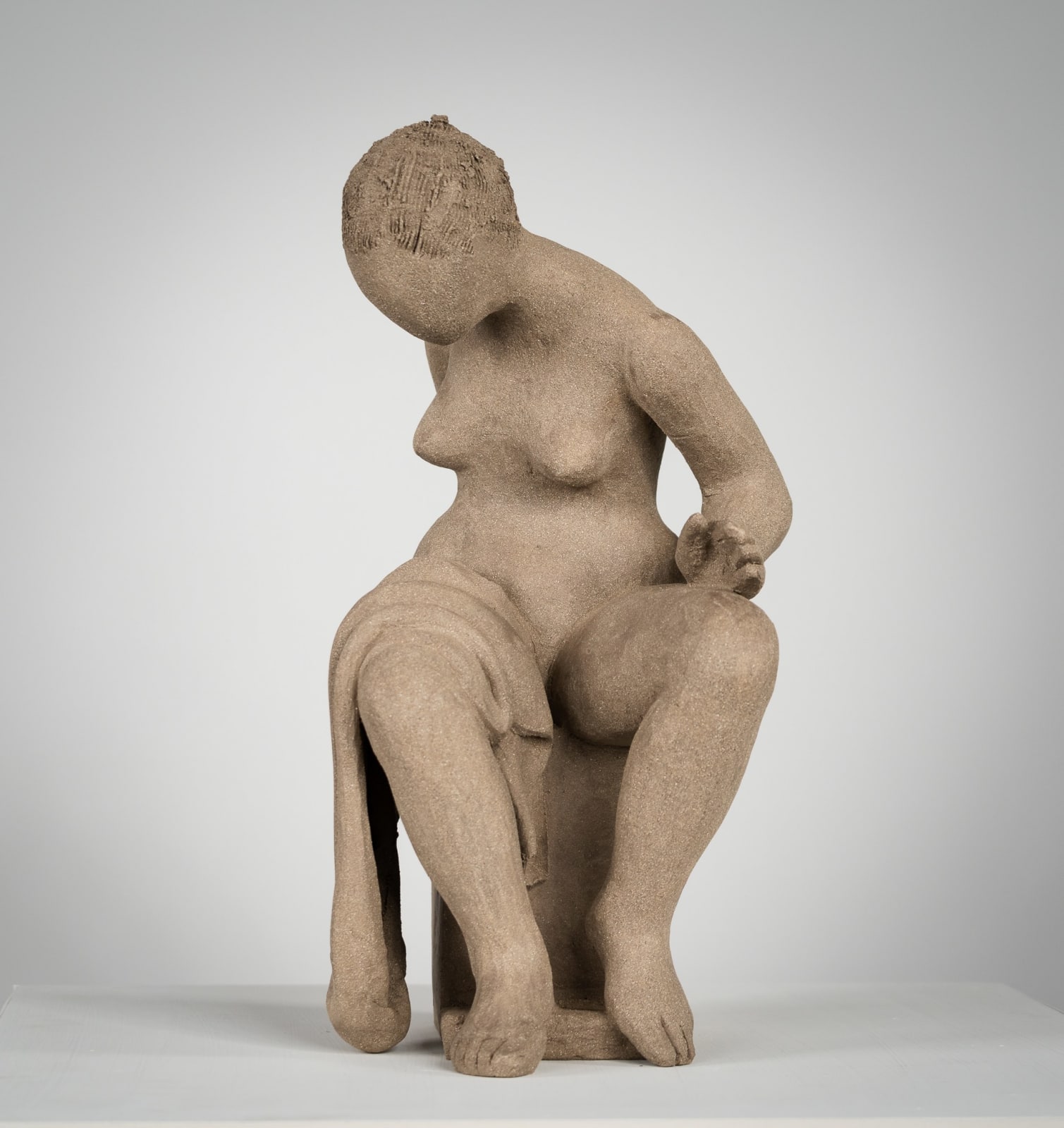 Figurative ceramics sculpture by artist Emilio DiIorio. Female figure is No. 4 in artist's Seated Bathers series in gray clay.