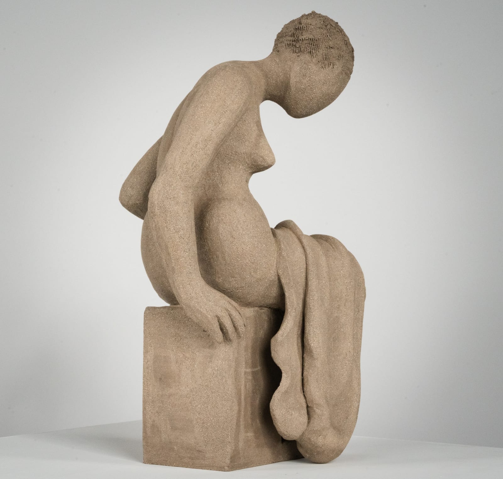 Figurative ceramics sculpture by artist Emilio DiIorio. Female figure is No. 4 in artist's Seated Bathers series in gray clay.