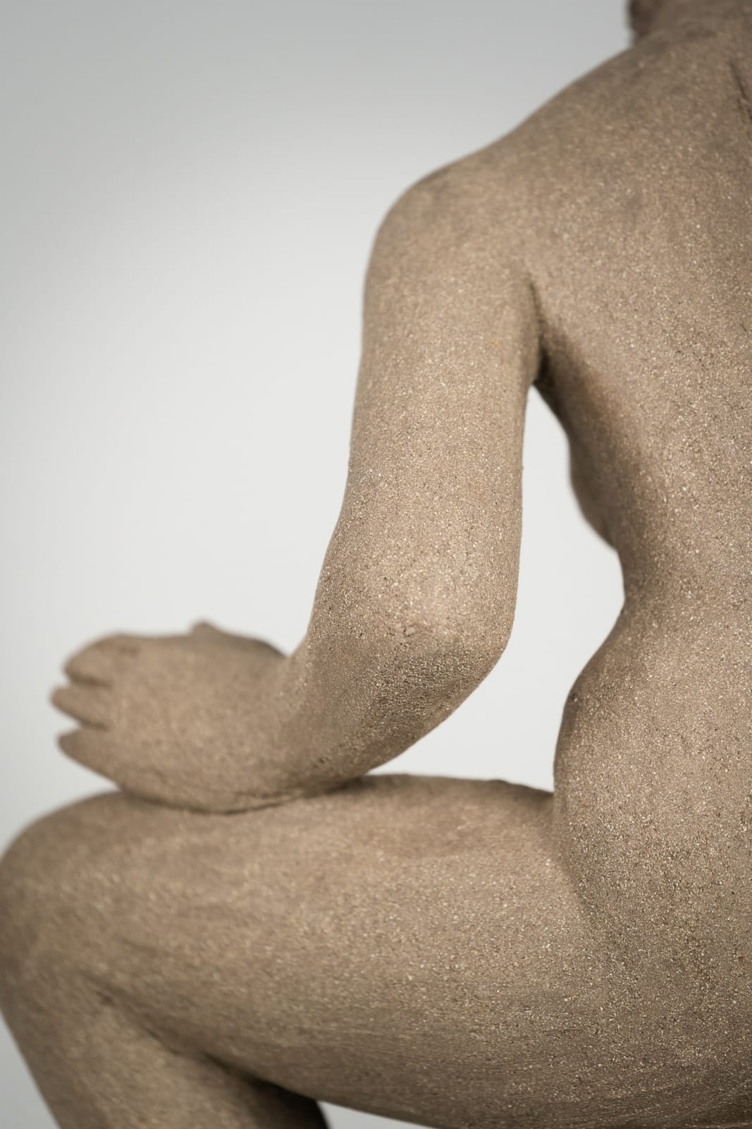 Figurative ceramics sculpture by artist Emilio DiIorio. Female figure is No. 4 in artist's Seated Bathers series in gray clay.