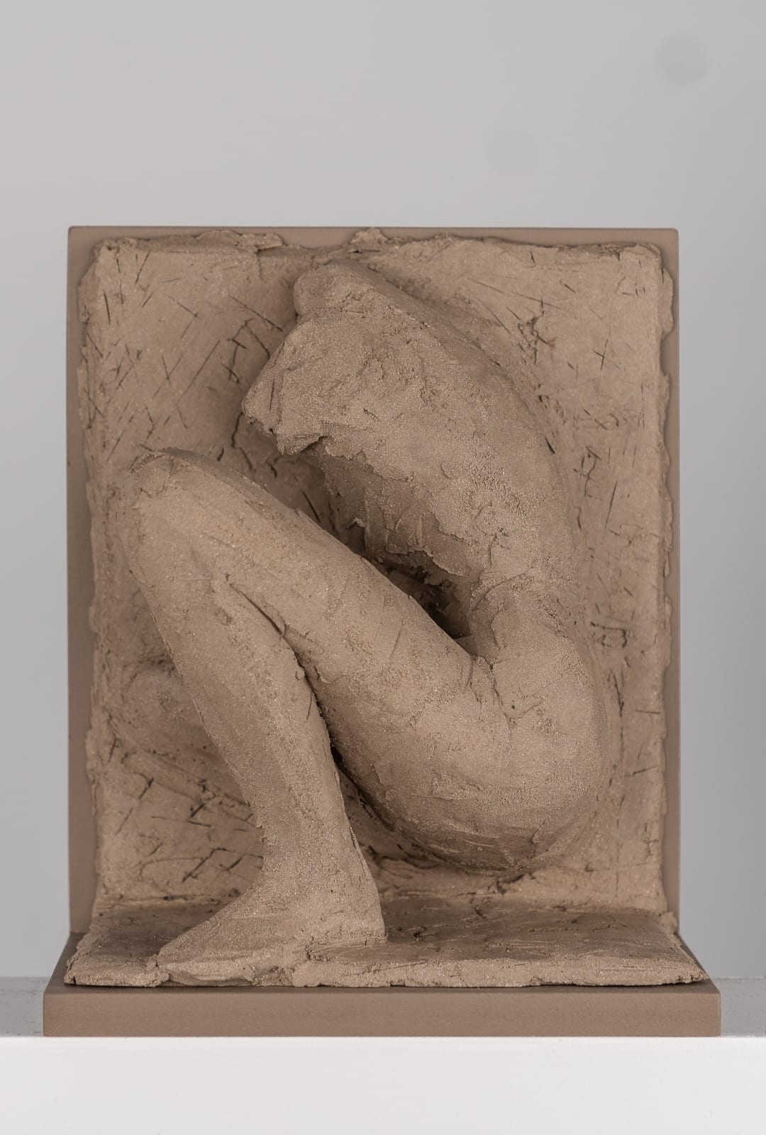 Figurative ceramic relief by artist Emilio DiIorio in Women of Troy series in gray clay.
