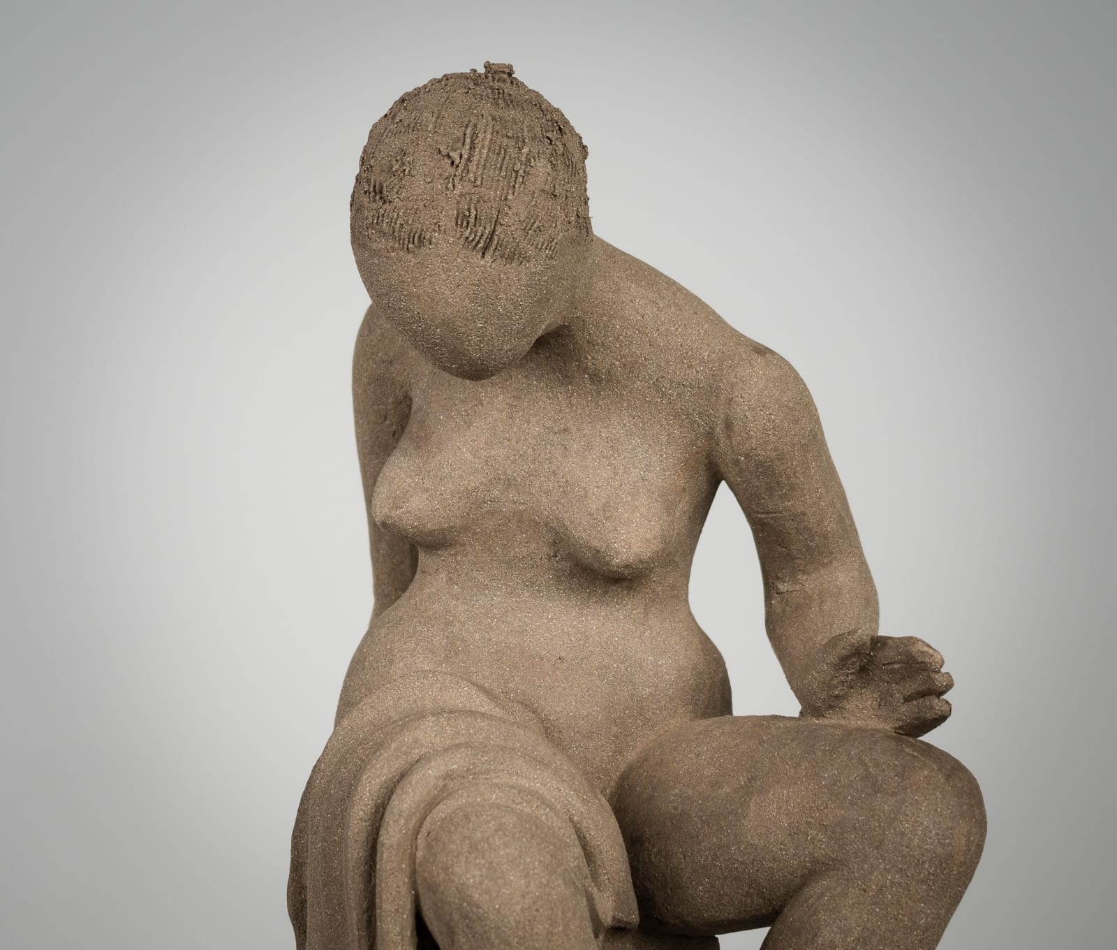 Figurative ceramics sculpture by artist Emilio DiIorio. Female figure is No. 4 in artist's Seated Bathers series in gray clay.