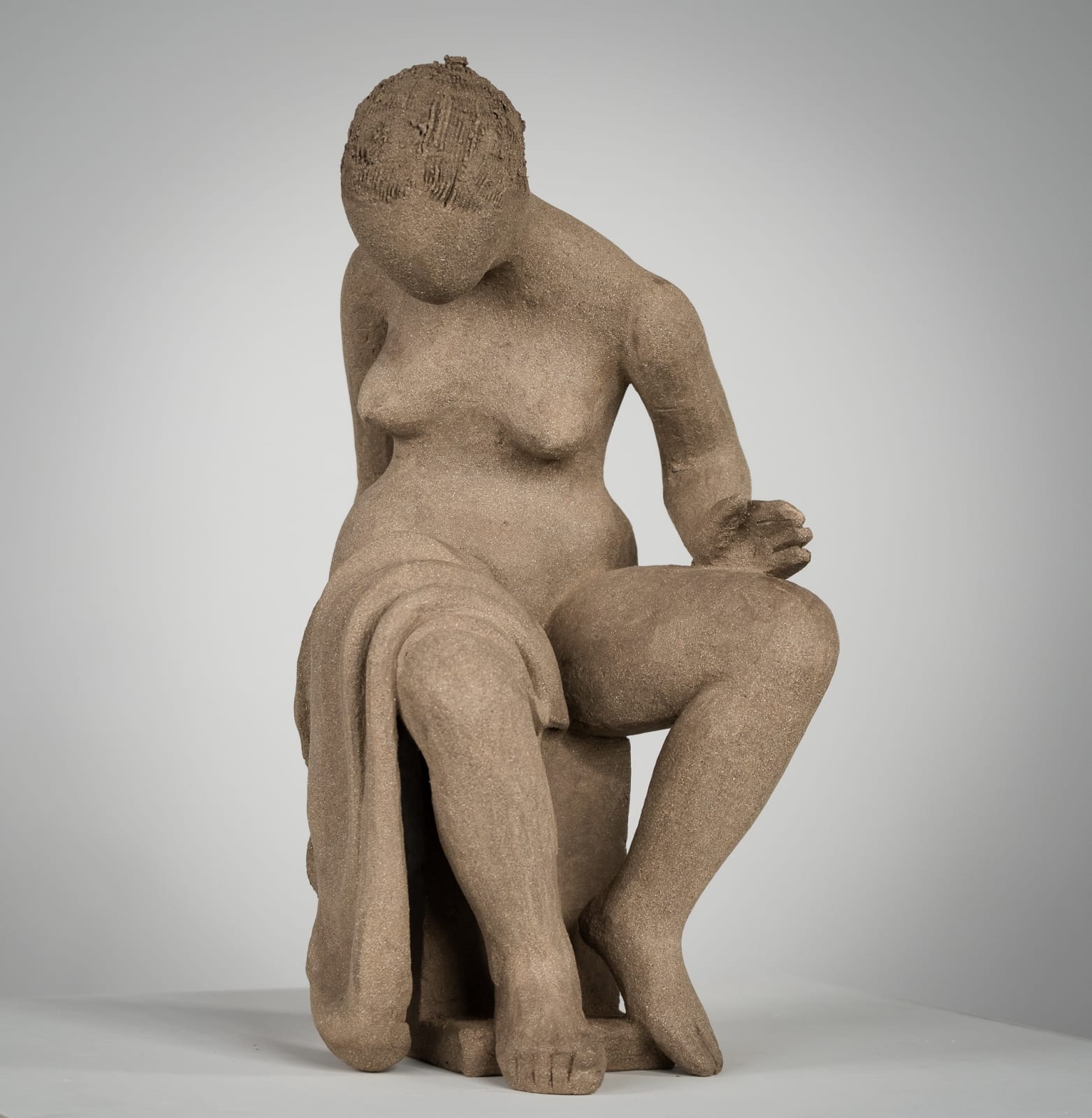 Figurative ceramics sculpture by artist Emilio DiIorio. Female figure is No. 4 in artist's Seated Bathers series in gray clay.