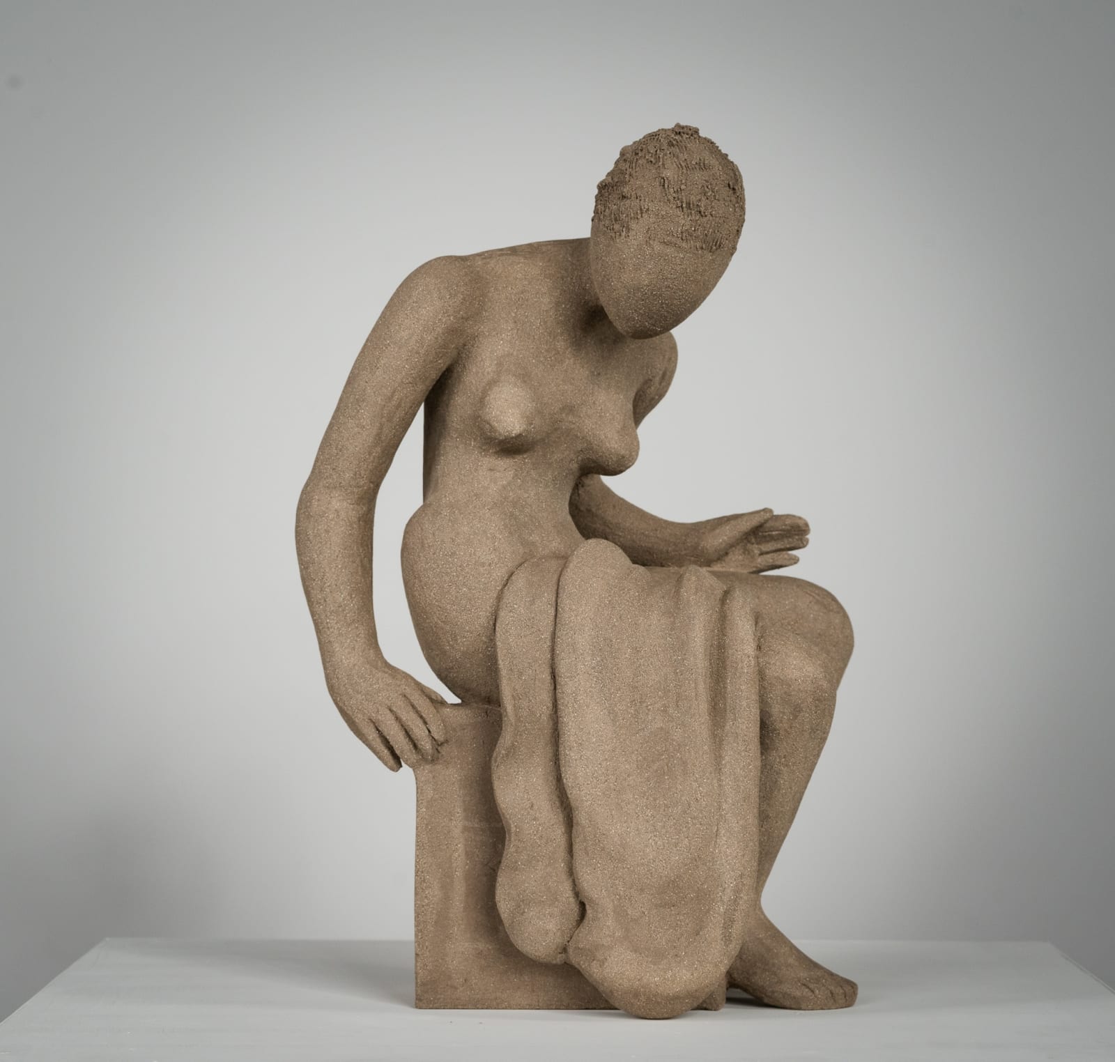 Figurative ceramics sculpture by artist Emilio DiIorio. Female figure is No. 4 in artist's Seated Bathers series in gray clay.