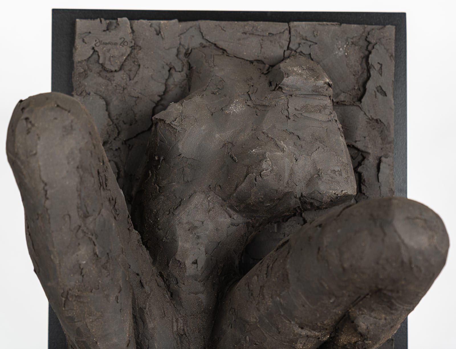 Ceramic relief in black clay in sculptor Emilio DiIorio's Women of Troy series.