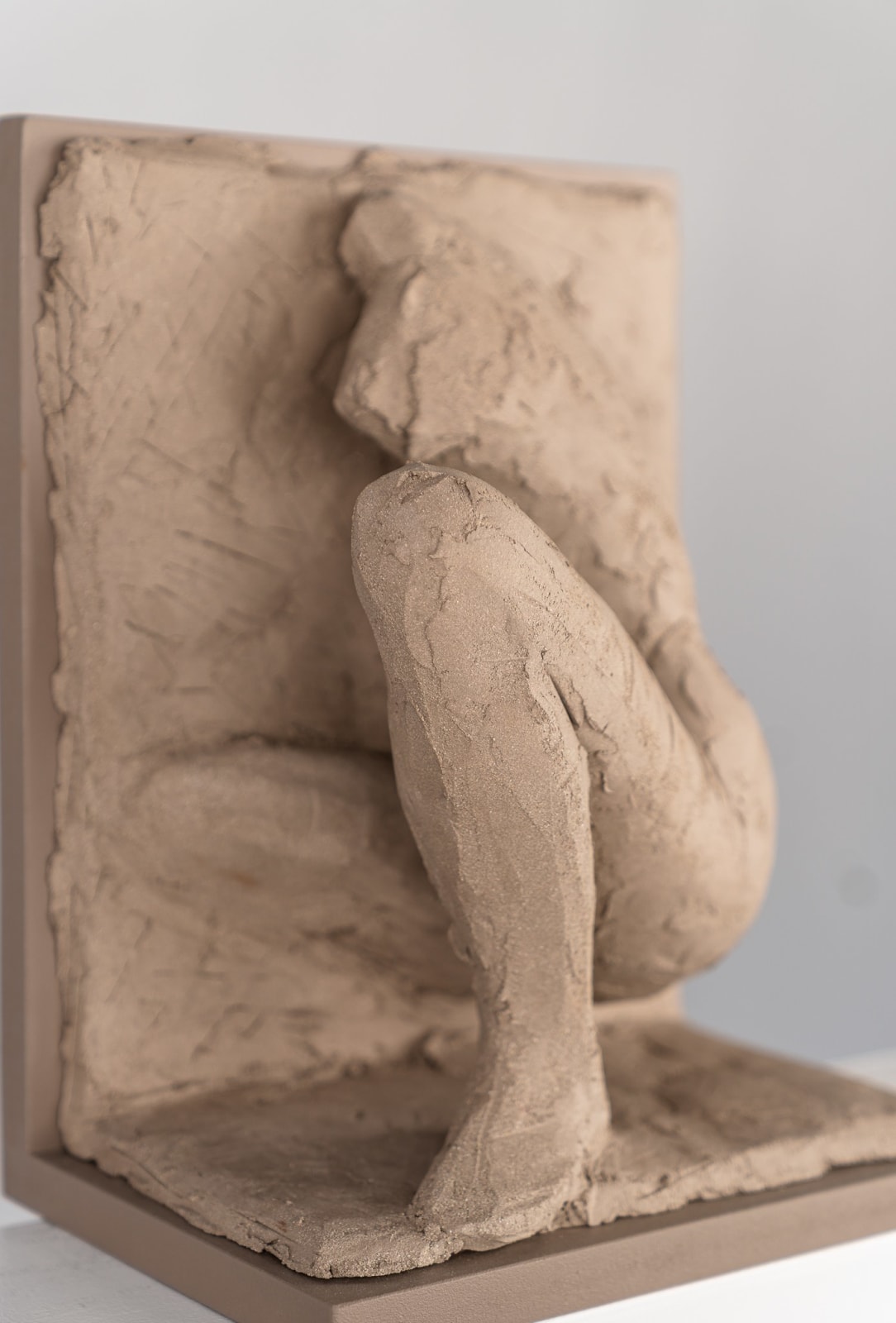Figurative ceramic relief by artist Emilio DiIorio in Women of Troy series in gray clay.