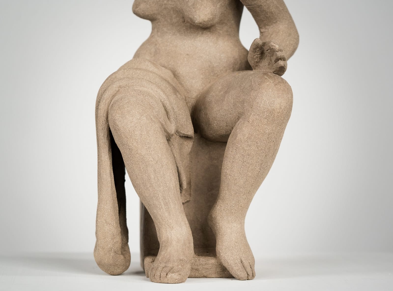 Figurative ceramics sculpture by artist Emilio DiIorio. Female figure is No. 4 in artist's Seated Bathers series in gray clay.