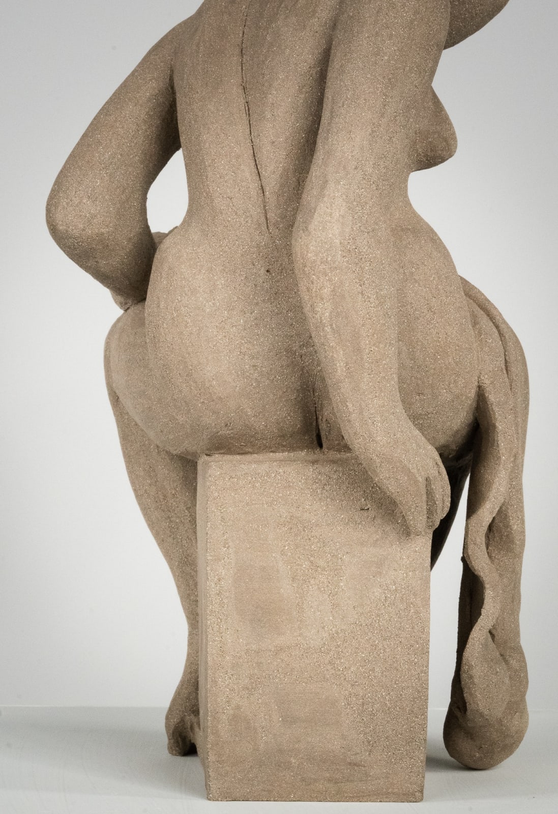 Figurative ceramics sculpture by artist Emilio DiIorio. Female figure is No. 4 in artist's Seated Bathers series in gray clay.