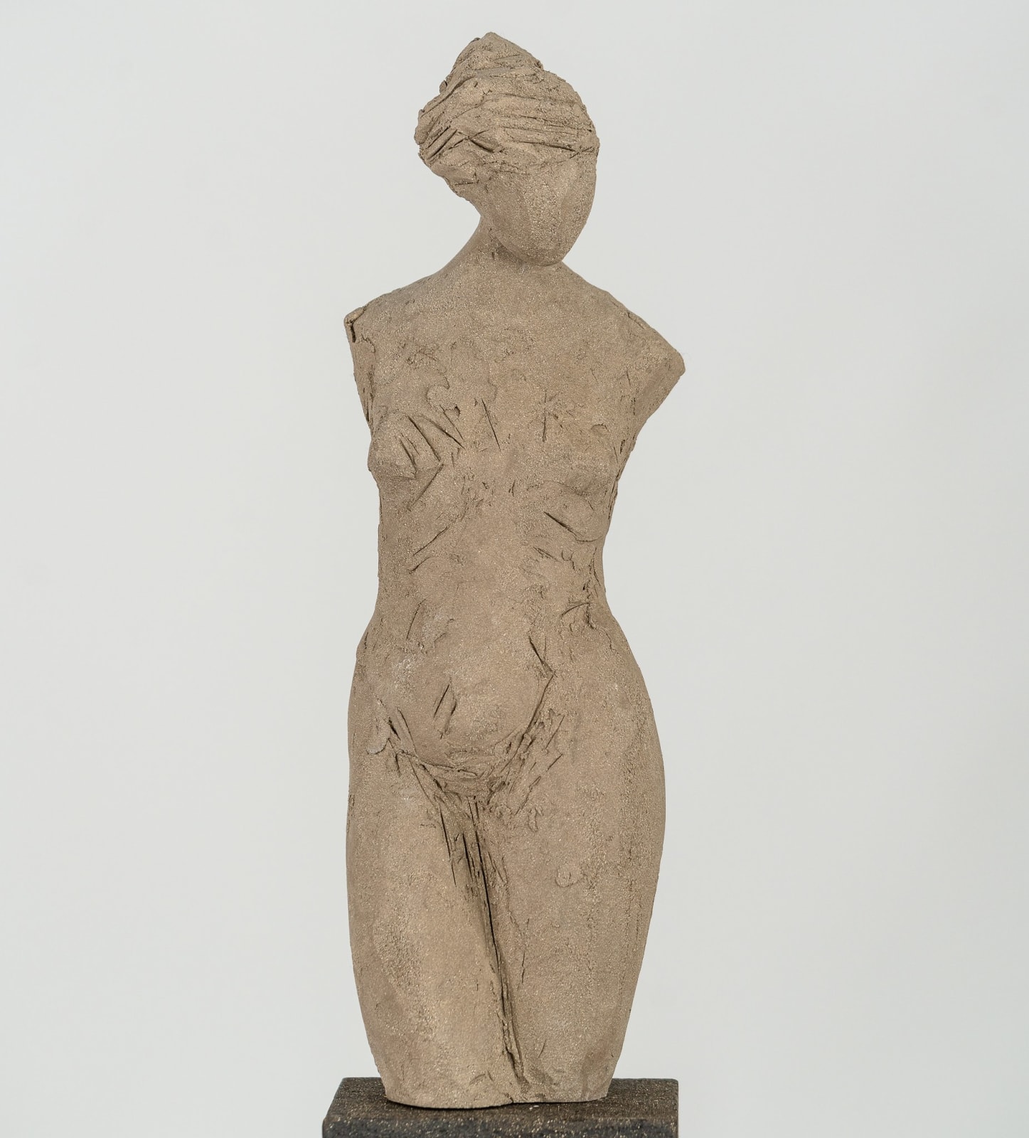 Fragmented figurative female torso in gray clay by sculptor Emilio DiIorio.