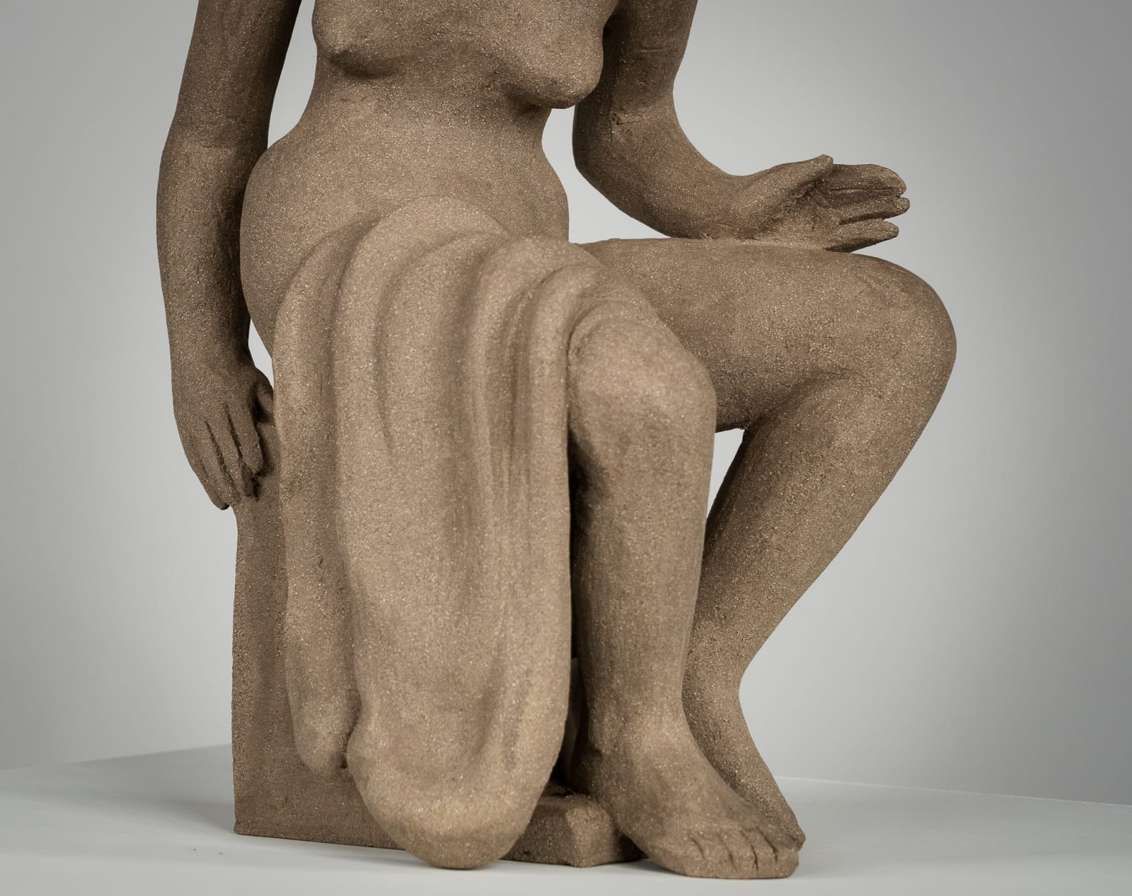 Figurative ceramics sculpture by artist Emilio DiIorio. Female figure is No. 4 in artist's Seated Bathers series in gray clay.