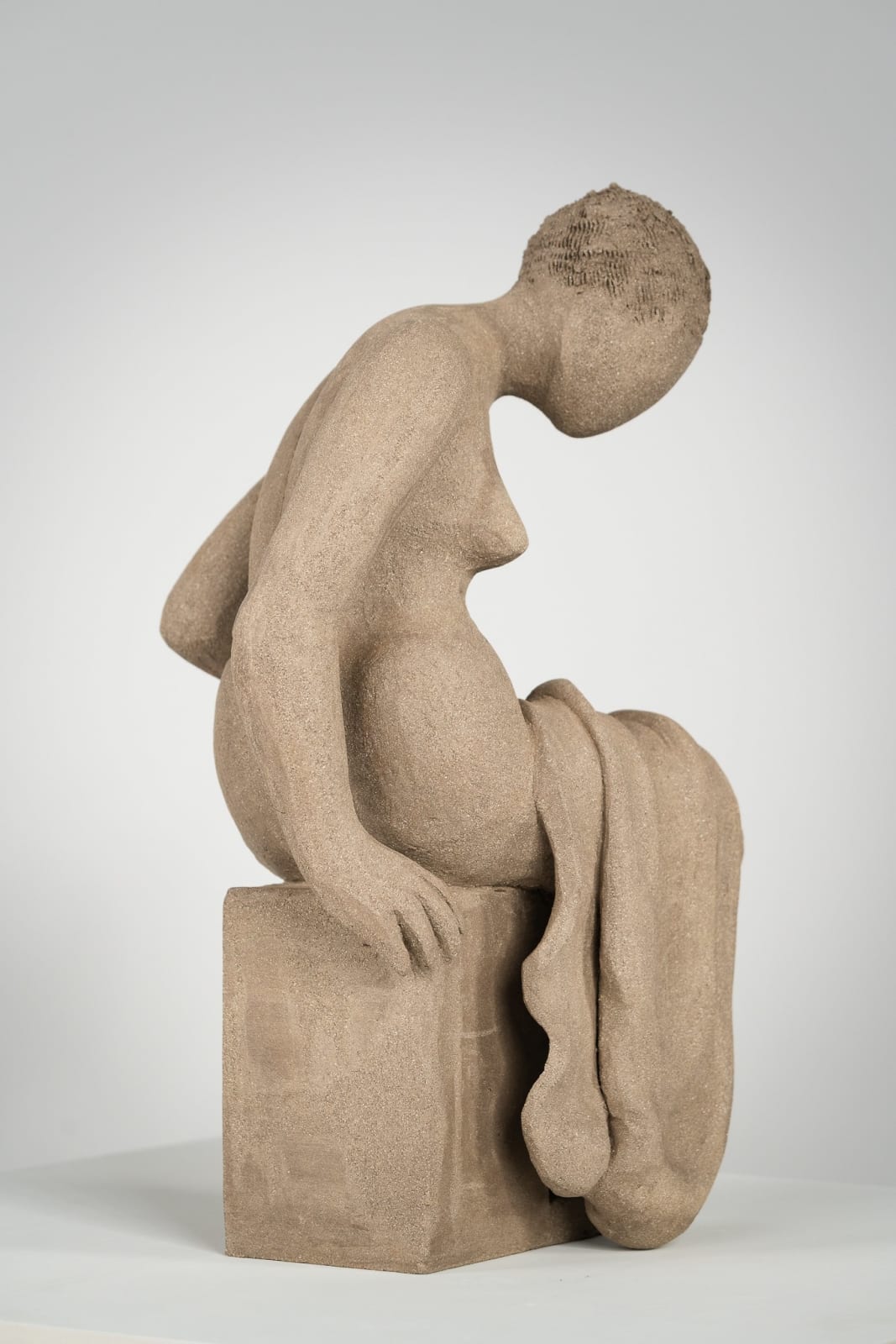 Figurative ceramics sculpture by artist Emilio DiIorio. Female figure is No. 4 in artist's Seated Bathers series in gray clay.