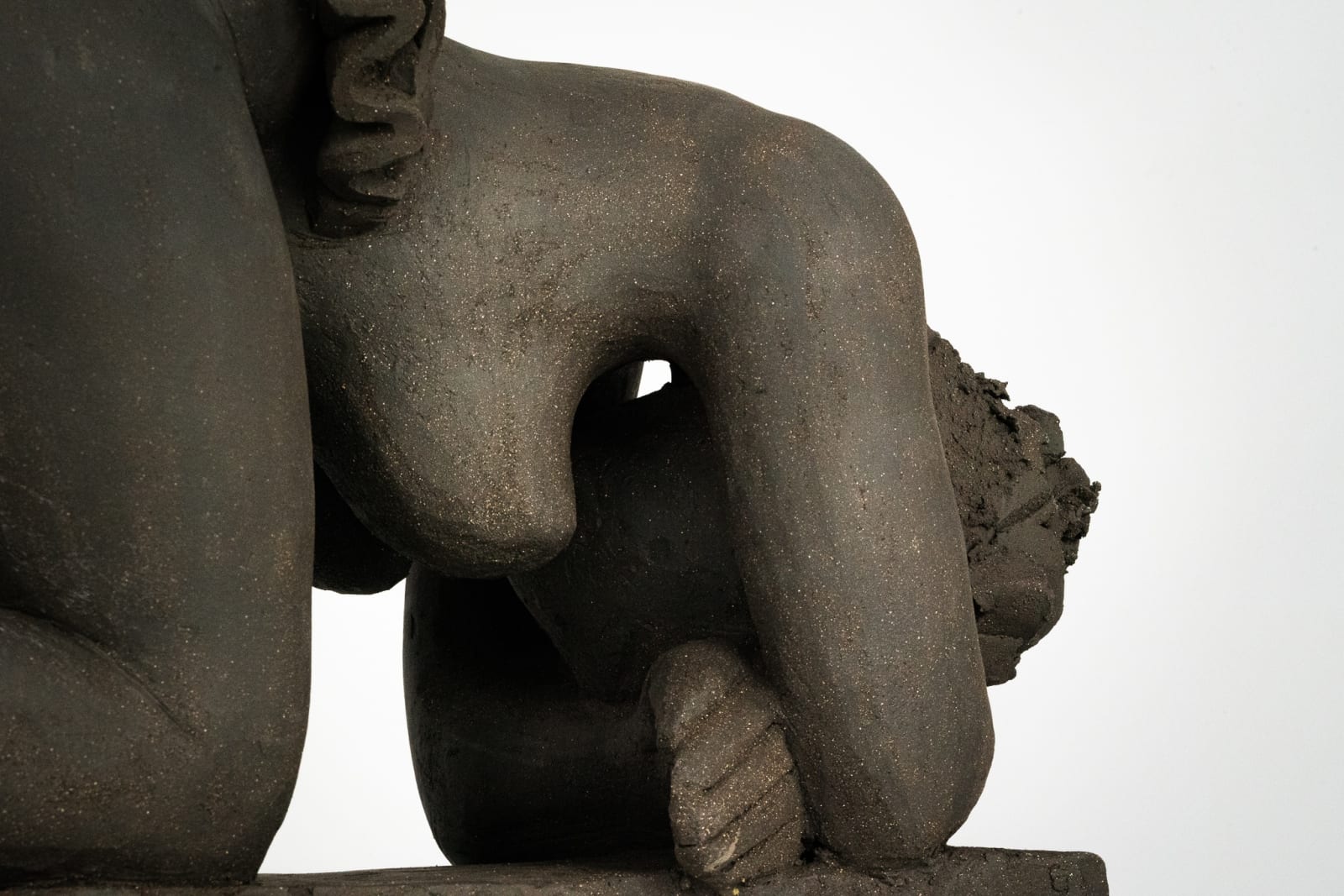 Figurative ceramics sculpture by artist Emilio DiIorio. Female figure is No. 5 in artist's Seated Bathers series in black clay.