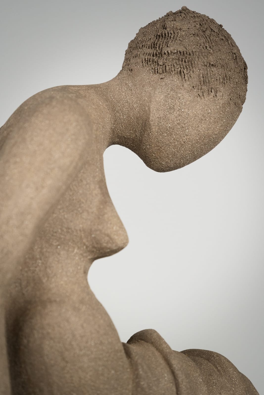 Figurative ceramics sculpture by artist Emilio DiIorio. Female figure is No. 4 in artist's Seated Bathers series in gray clay.