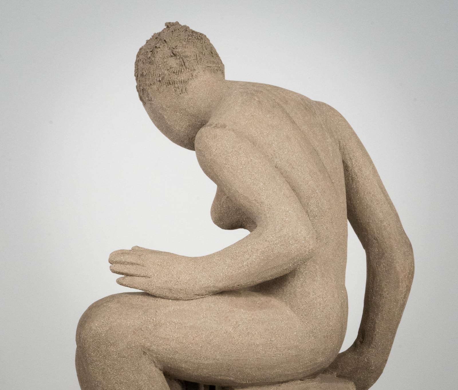 Figurative ceramics sculpture by artist Emilio DiIorio. Female figure is No. 4 in artist's Seated Bathers series in gray clay.