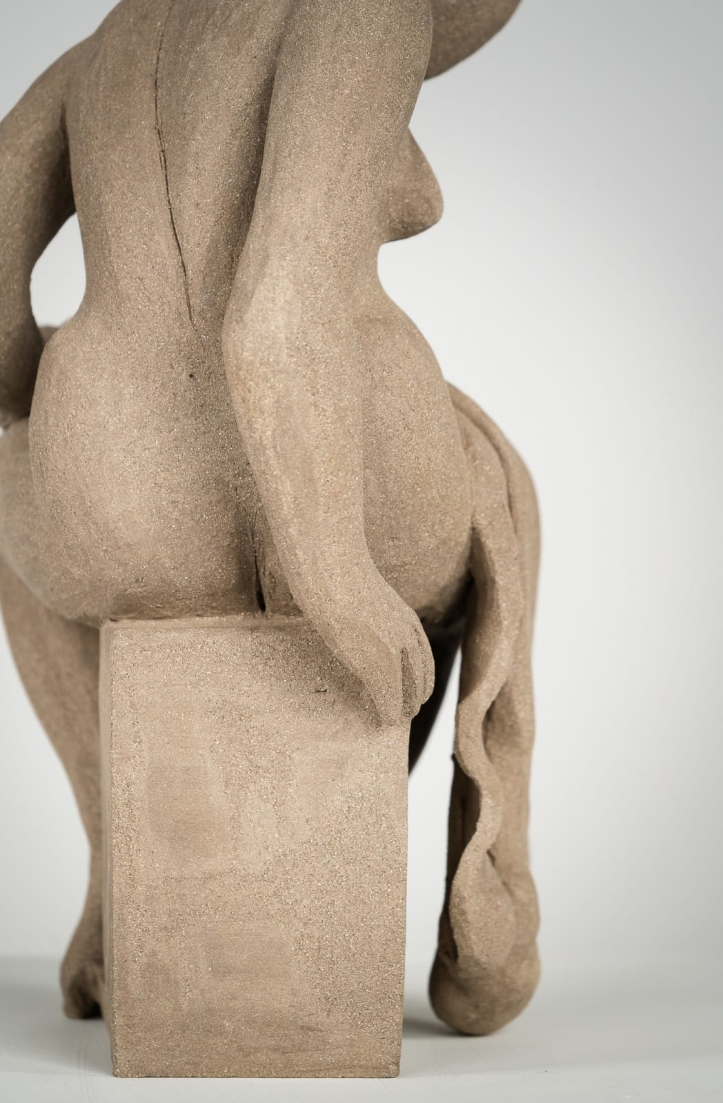 Figurative ceramics sculpture by artist Emilio DiIorio. Female figure is No. 4 in artist's Seated Bathers series in gray clay.