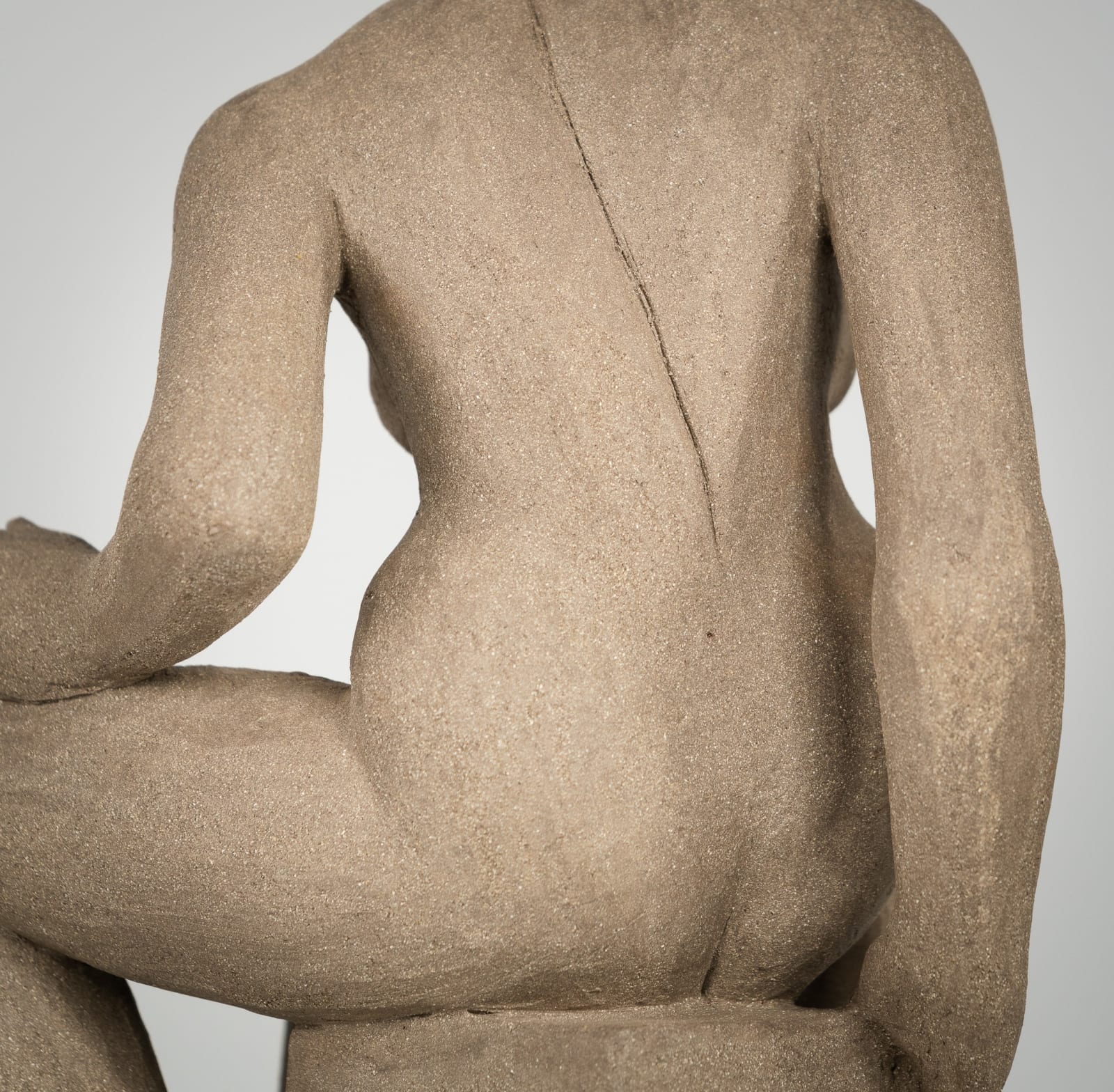 Figurative ceramics sculpture by artist Emilio DiIorio. Female figure is No. 4 in artist's Seated Bathers series in gray clay.