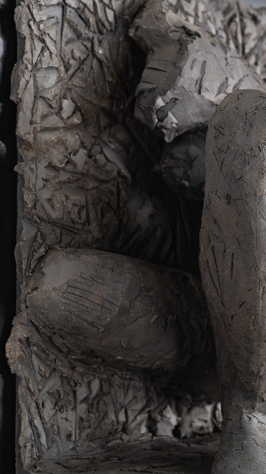 Ceramic relief in black clay in sculptor Emilio DiIorio's Women of Troy series.