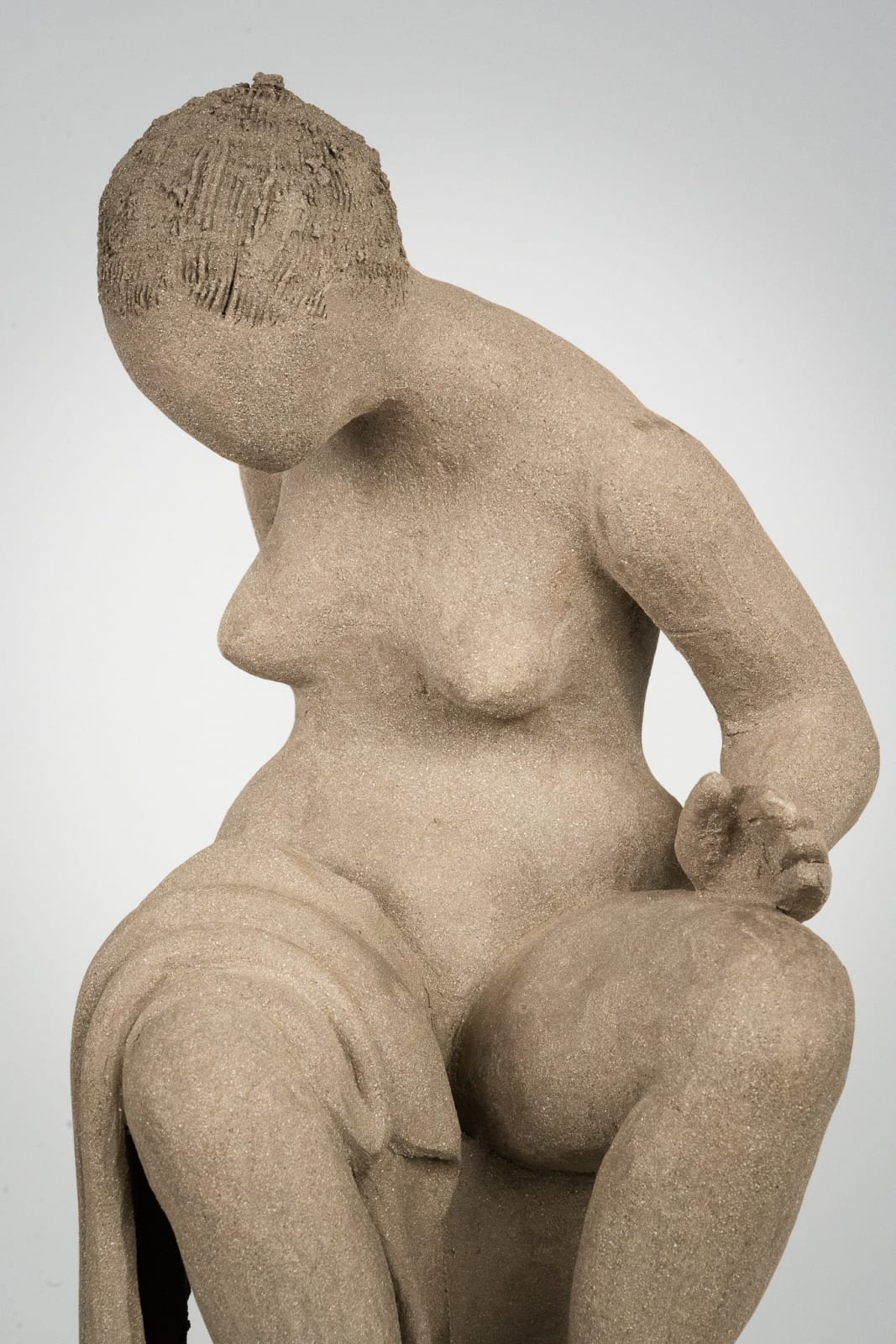 Figurative ceramics sculpture by artist Emilio DiIorio. Female figure is No. 4 in artist's Seated Bathers series in gray clay.