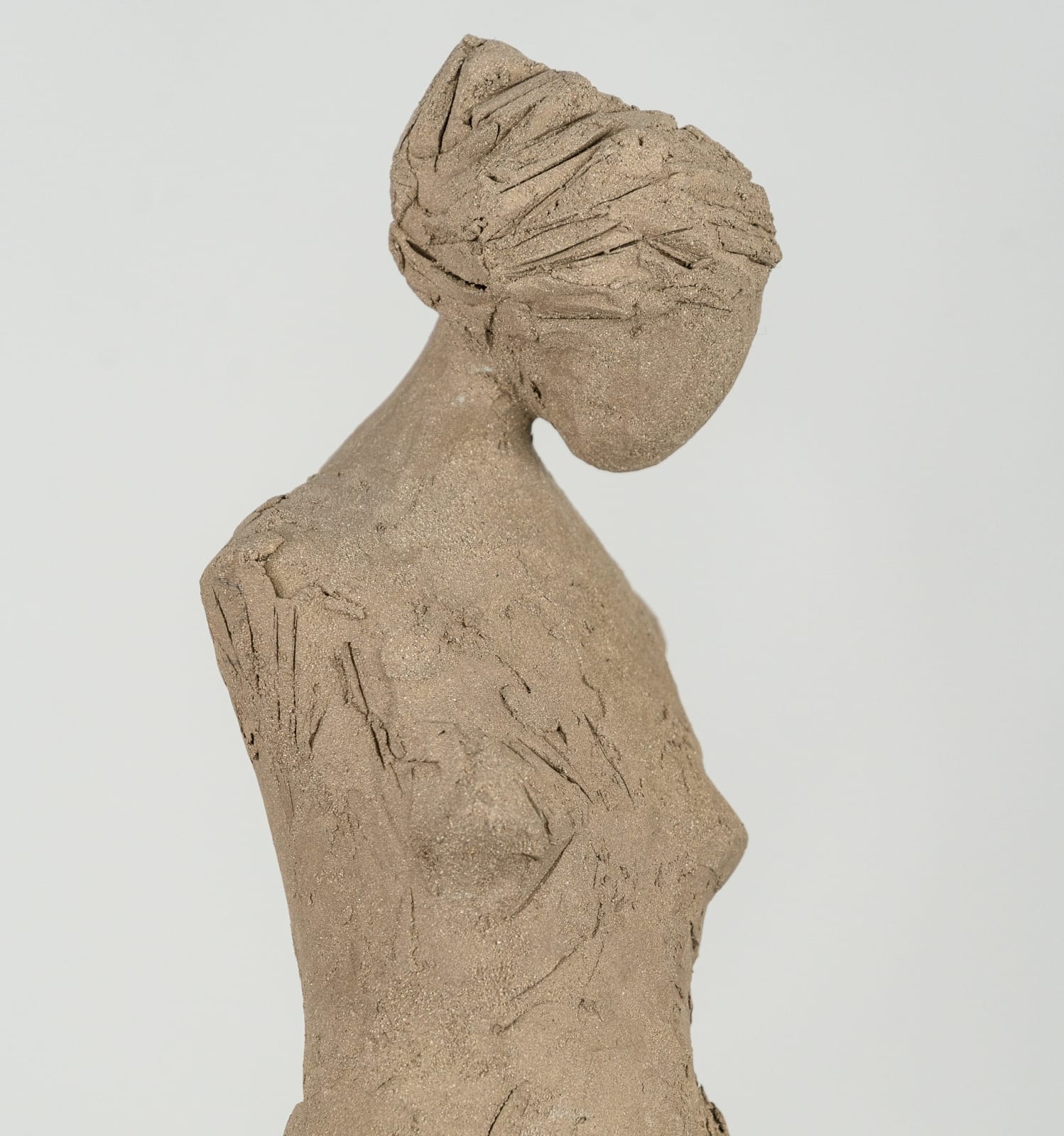 Fragmented figurative female torso in gray clay by sculptor Emilio DiIorio.