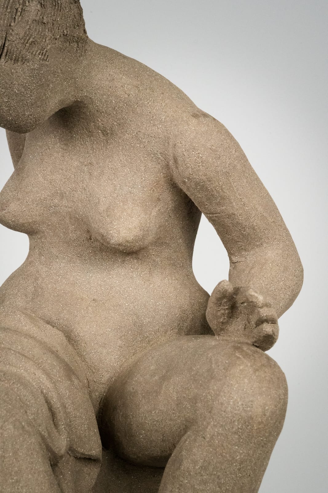 Figurative ceramics sculpture by artist Emilio DiIorio. Female figure is No. 4 in artist's Seated Bathers series in gray clay.