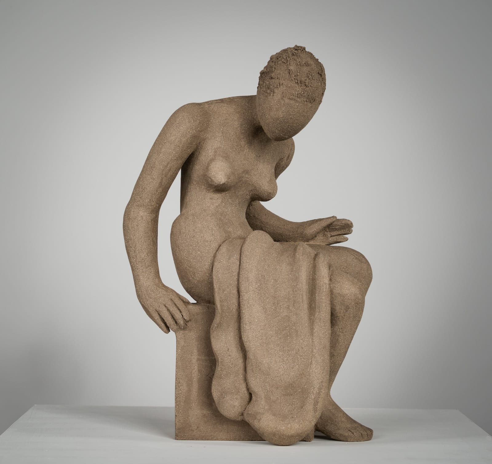 Figurative ceramics sculpture by artist Emilio DiIorio. Female figure is No. 4 in artist's Seated Bathers series in gray clay.