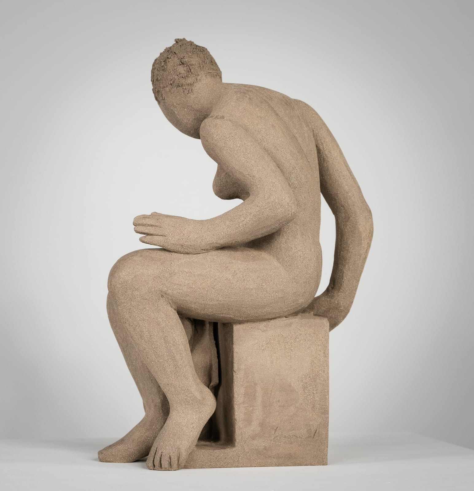 Figurative ceramics sculpture by artist Emilio DiIorio. Female figure is No. 4 in artist's Seated Bathers series in gray clay.