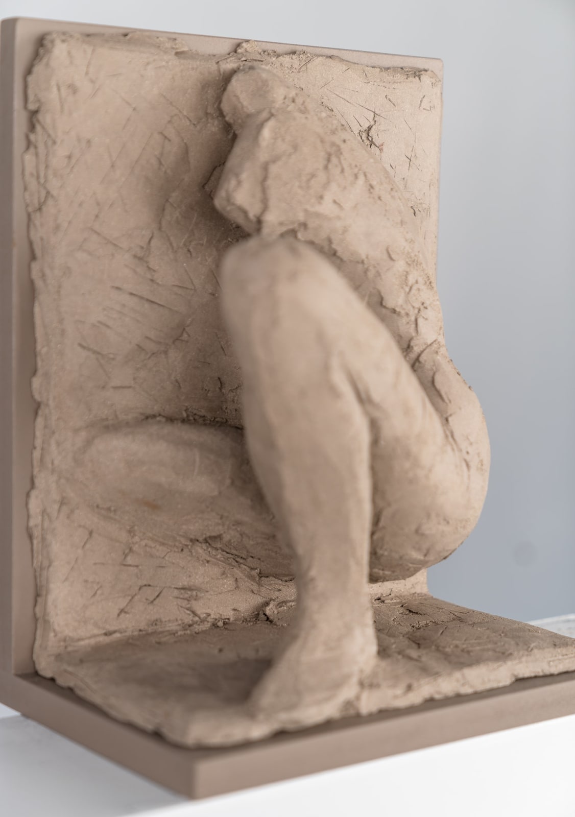 Figurative ceramic relief by artist Emilio DiIorio in Women of Troy series in gray clay.