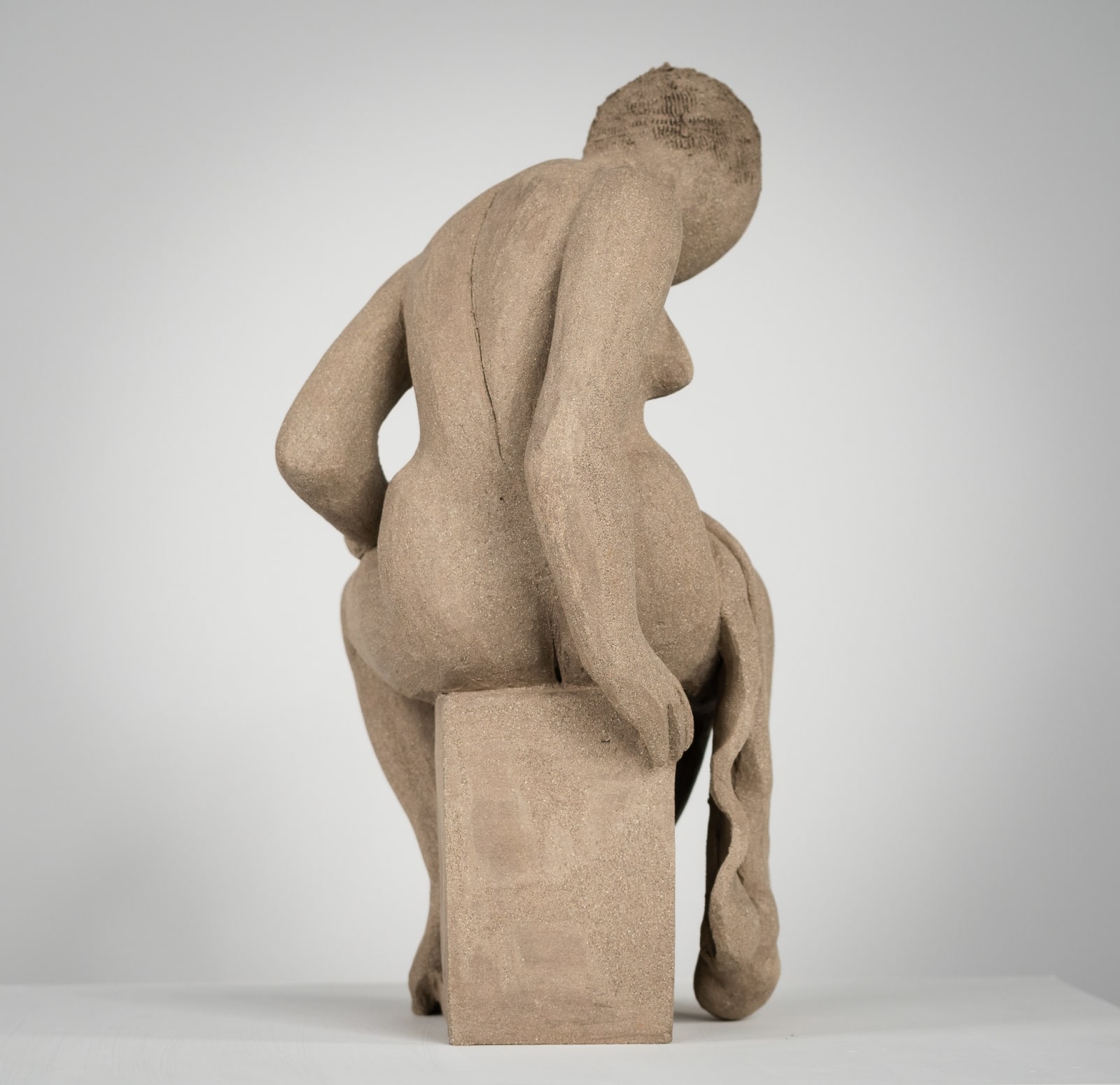 Figurative ceramics sculpture by artist Emilio DiIorio. Female figure is No. 4 in artist's Seated Bathers series in gray clay.