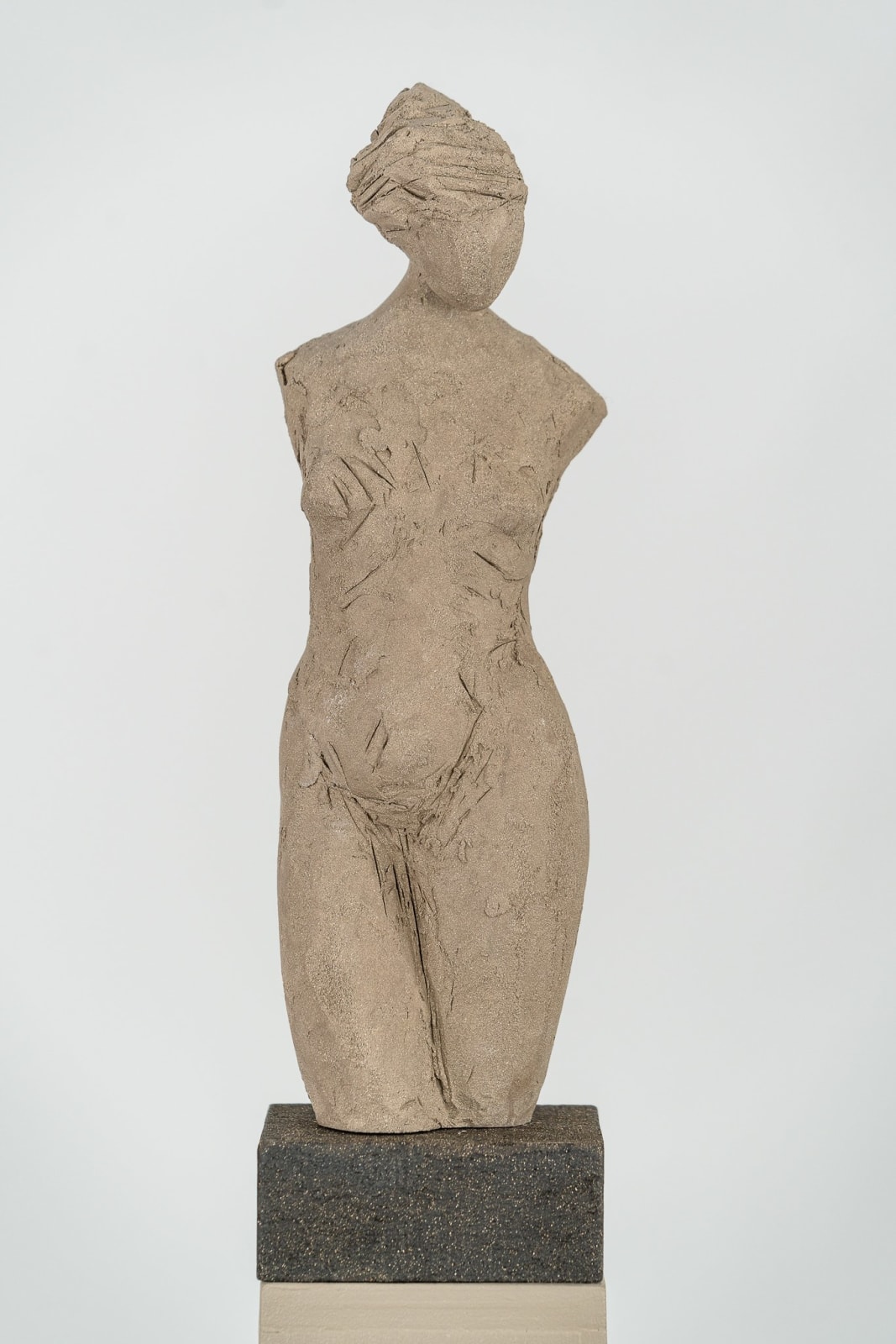 Fragmented figurative female torso in gray clay by sculptor Emilio DiIorio.