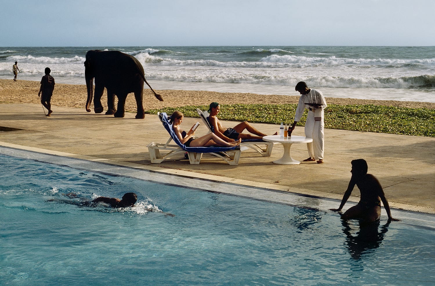 Steve McCurry, Tourists lounge poolside, Sri Lanka, 1995