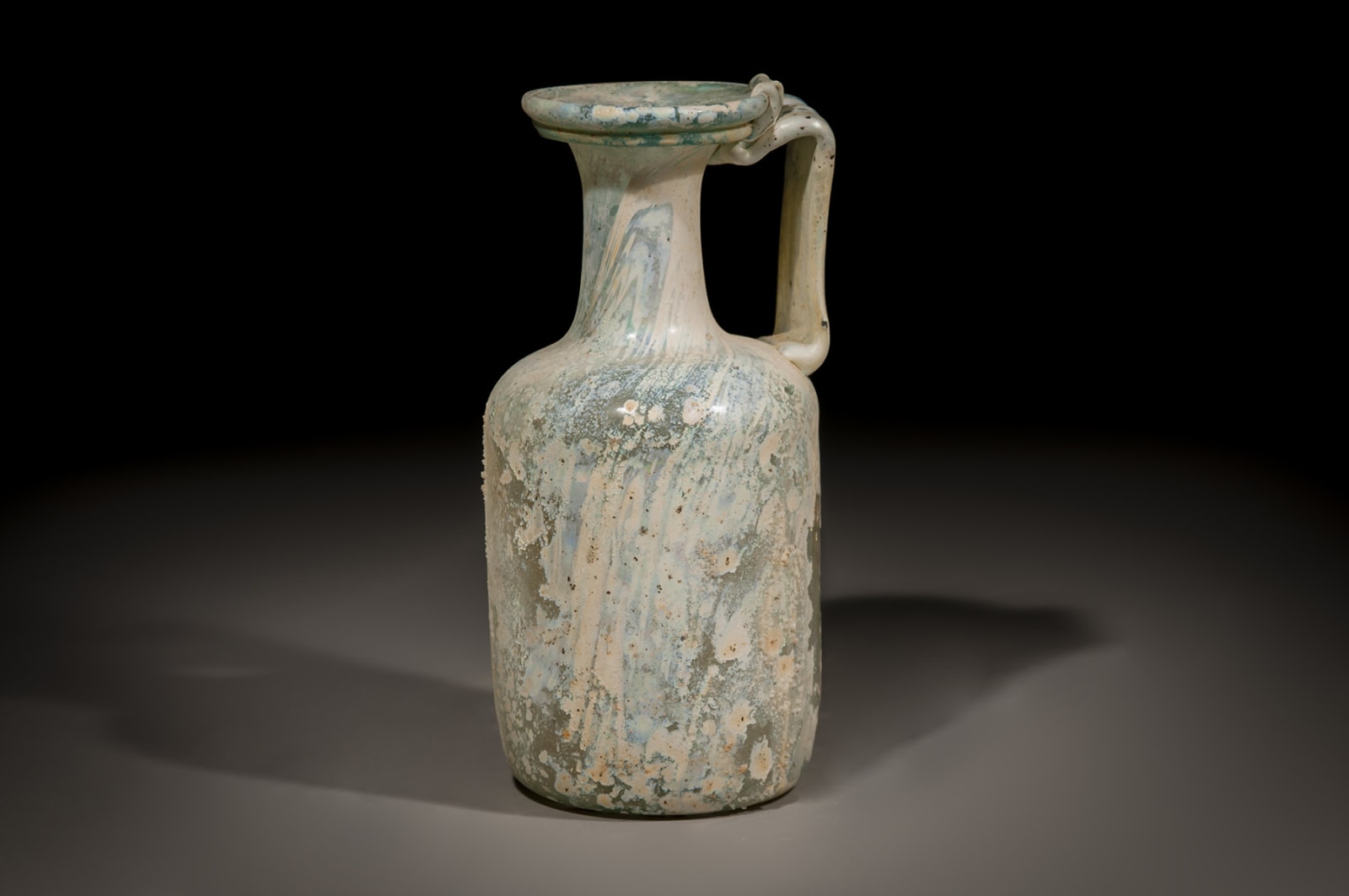 A Roman Glass Jug with a handle, Early/Middle Roman Period, 100 C.E. - 200 C.E.