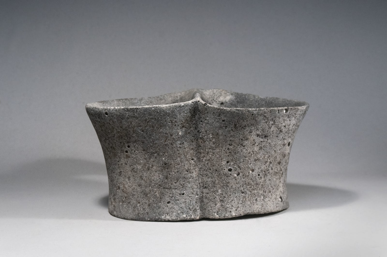 A Large Basalt Stone Double Mug, Chalcolithic period, Circa 3100 B C.E.