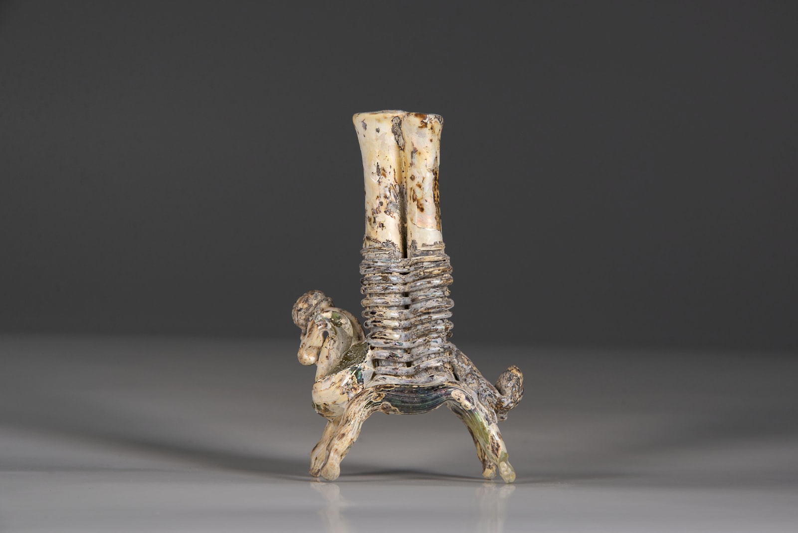 A Glass horse carrying double kohl flask, Islamic period 8th century C.E.