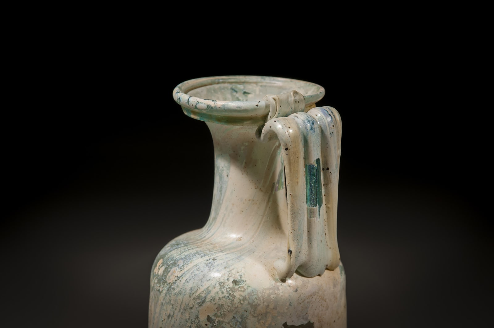 A Roman Glass Jug with a handle, Early/Middle Roman Period, 100 C.E. - 200 C.E.