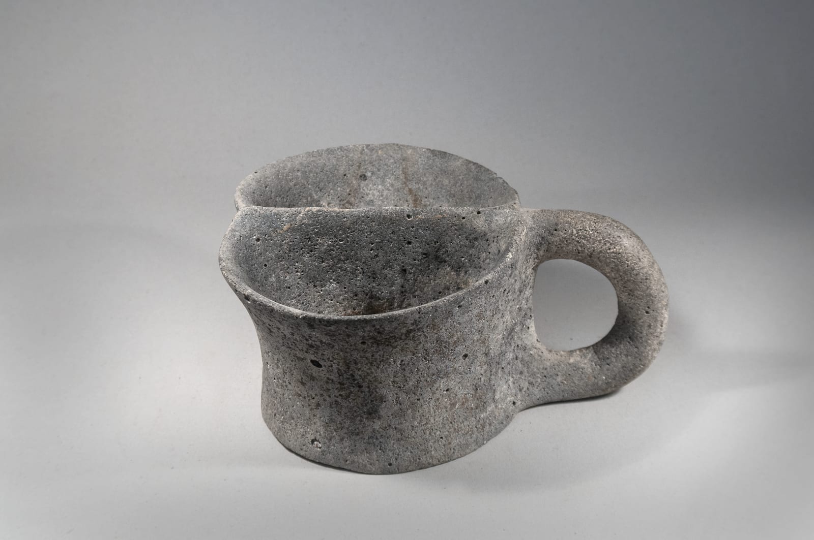 A Large Basalt Stone Double Mug, Chalcolithic period, Circa 3100 B C.E.