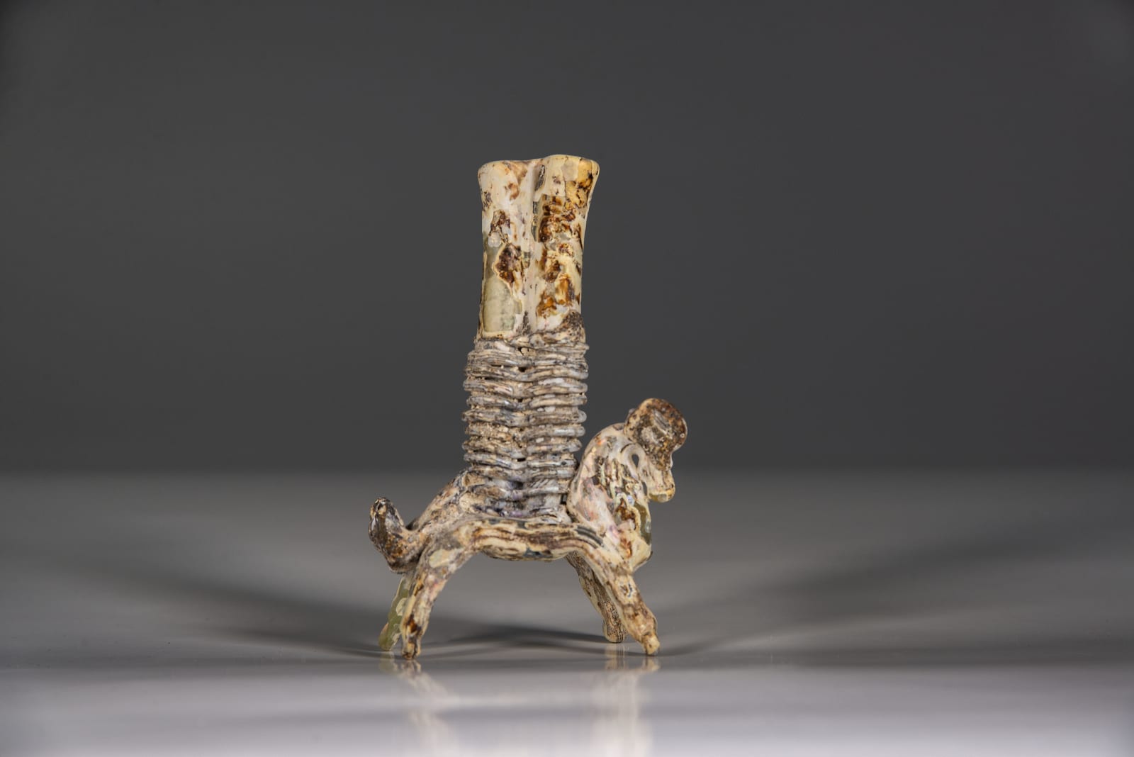 A Glass horse carrying double kohl flask, Islamic period 8th century C.E.