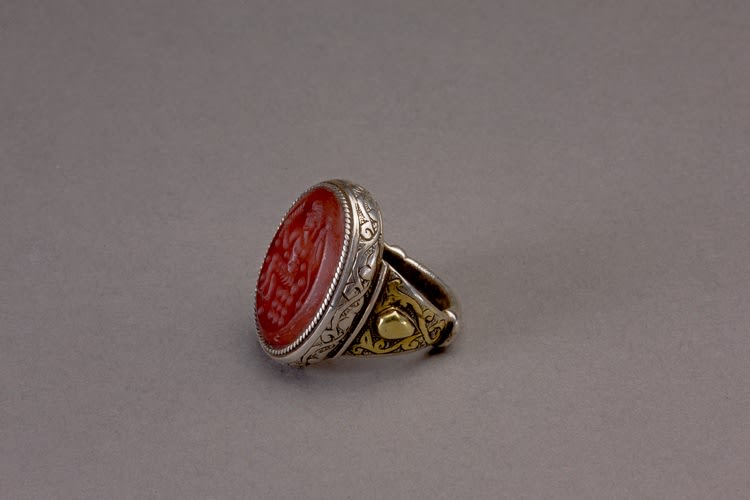 Oval silver Islamic ring with carnelian intaglio of a seated figure in profile to the right