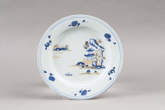 Plate decorated with coastal scenery and pagoda in the background