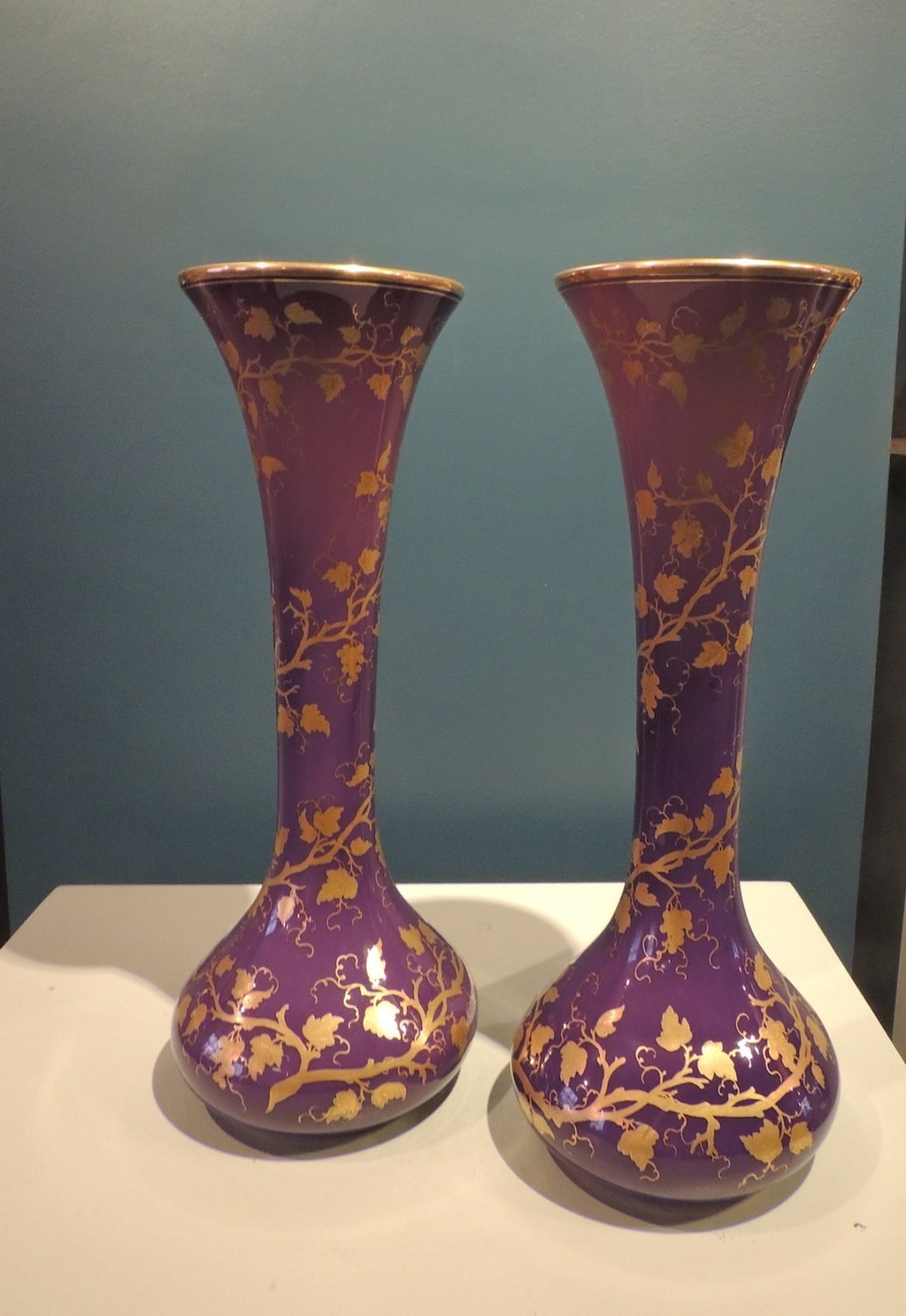 Pair of mauve glass vases with golden decoration