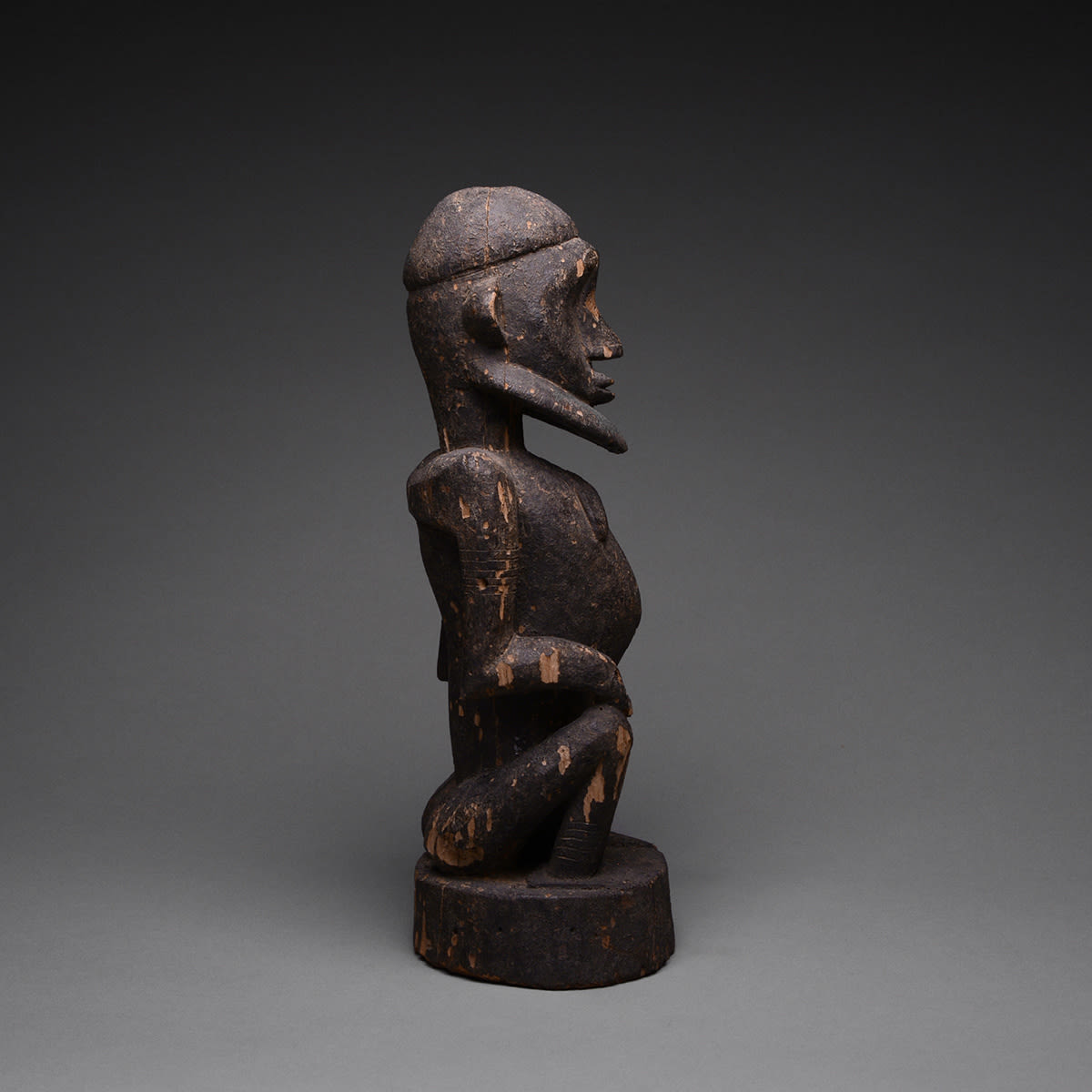 Dogon Wooden Sculpture of a Seated Man, 20th Century CE