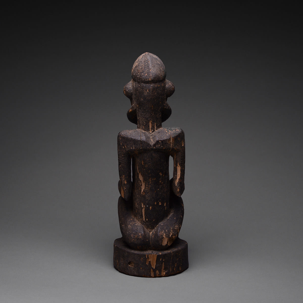 Dogon Wooden Sculpture of a Seated Man, 20th Century CE
