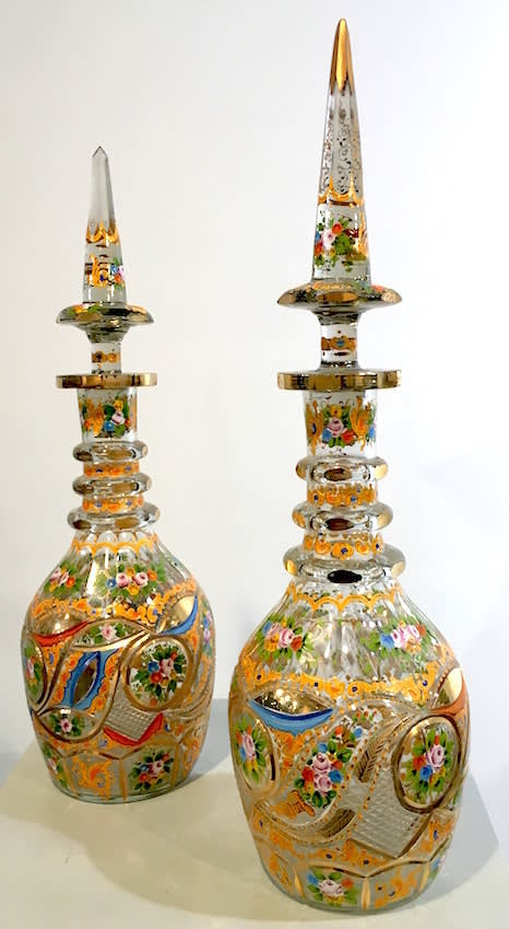 Qajar period pair of glass decanters with painted floral decoration, 19th Century CE