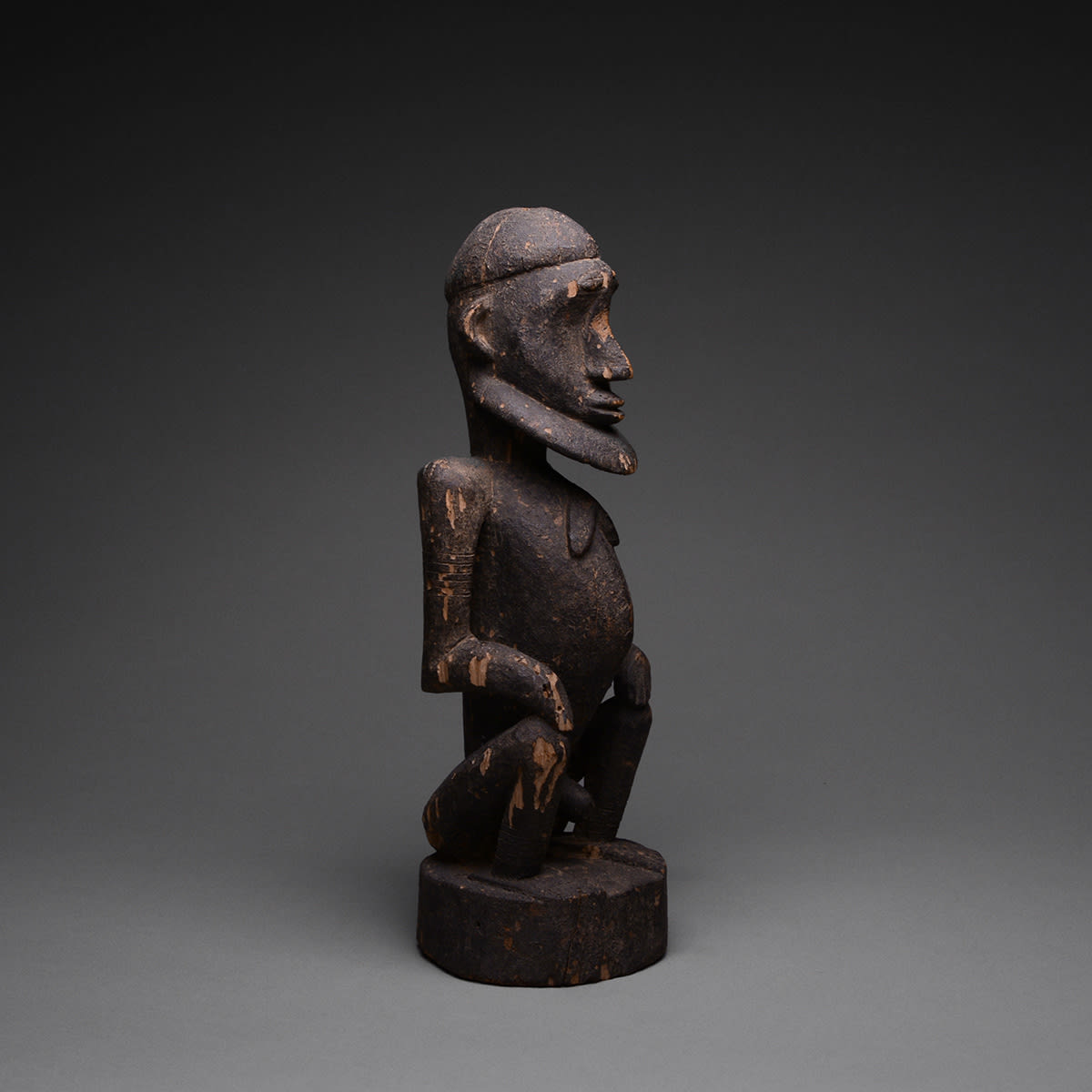 Dogon Wooden Sculpture of a Seated Man, 20th Century CE